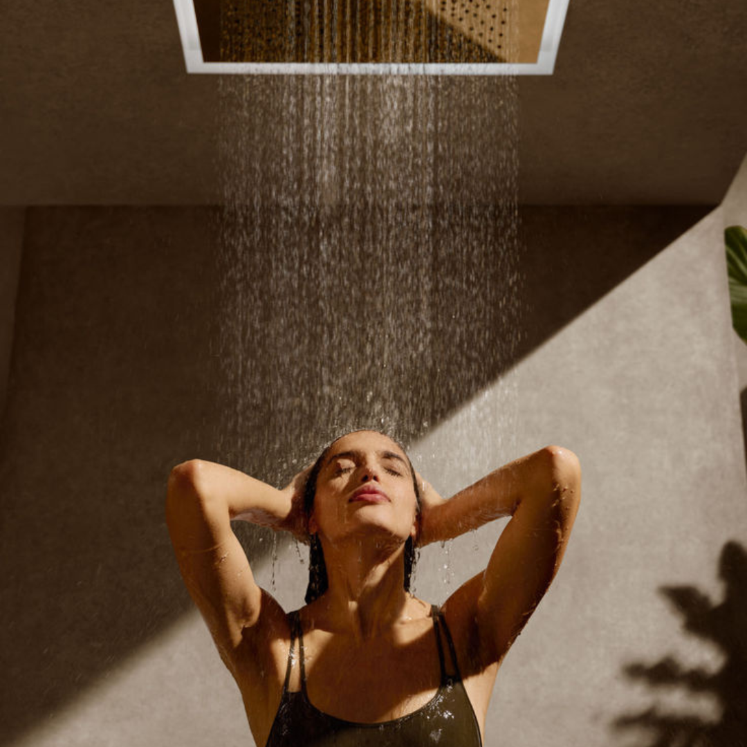 Guest rinsing off under a shower after the sauna