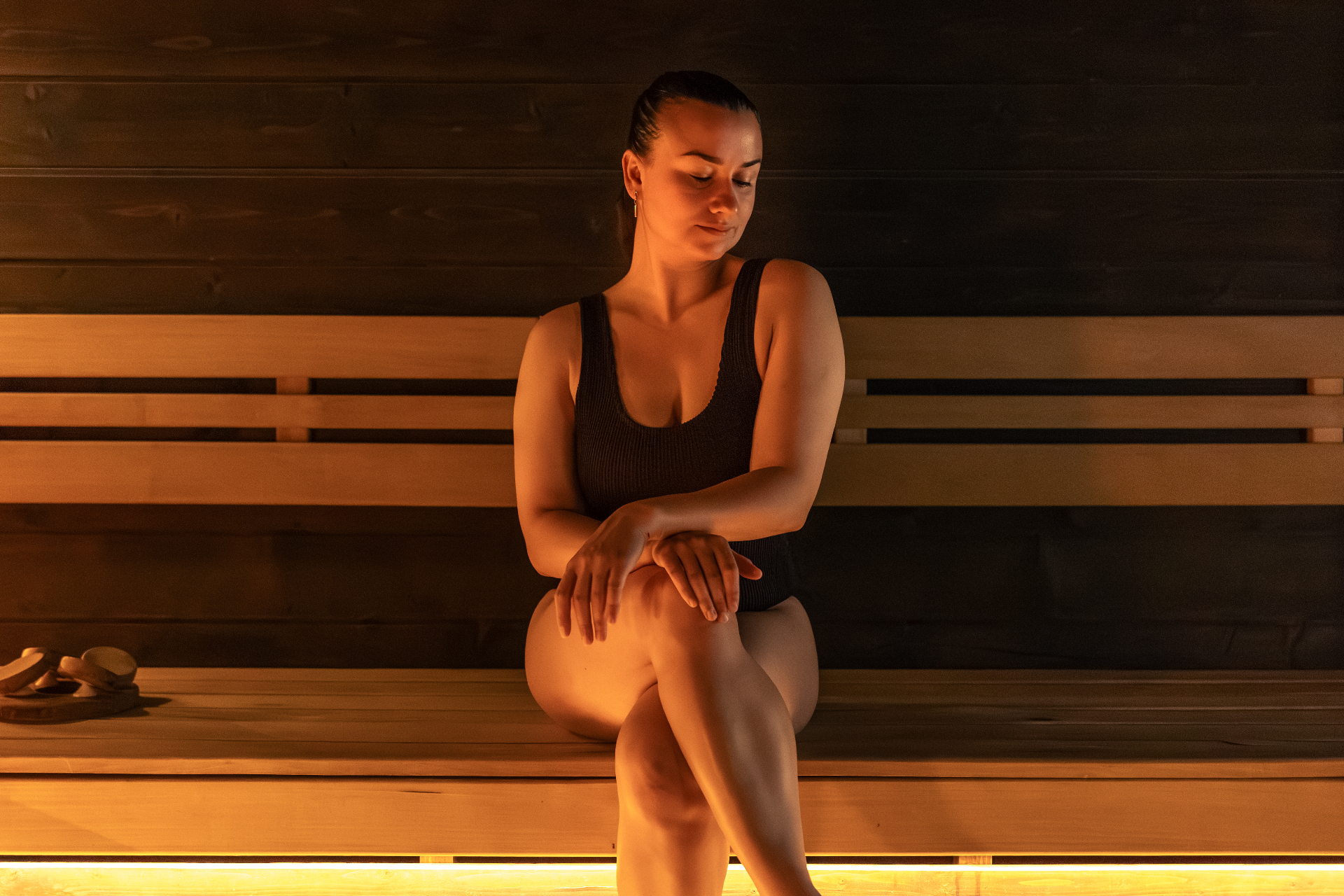 Warm cedar sauna interior with wooden benches and soft ambient lighting
